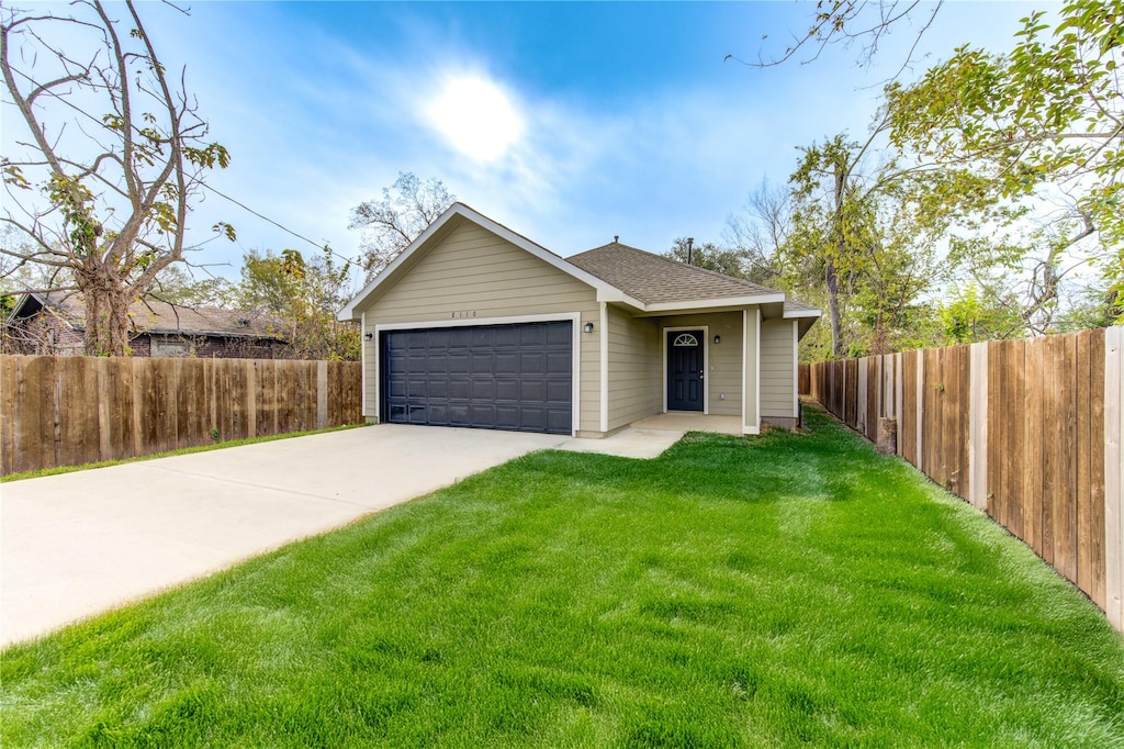 view of front facade with a garage and a front lawn