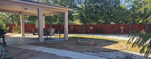 view of yard with a patio area and an outdoor fire pit