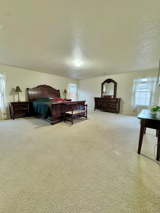 carpeted bedroom featuring a textured ceiling