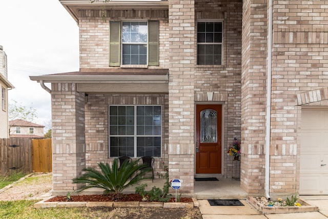 view of exterior entry with a garage