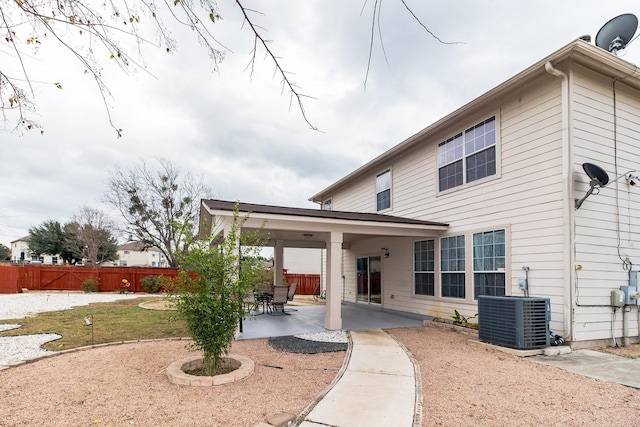 rear view of house with a patio and cooling unit