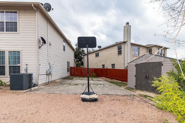 back of house featuring a storage unit, a patio, and cooling unit