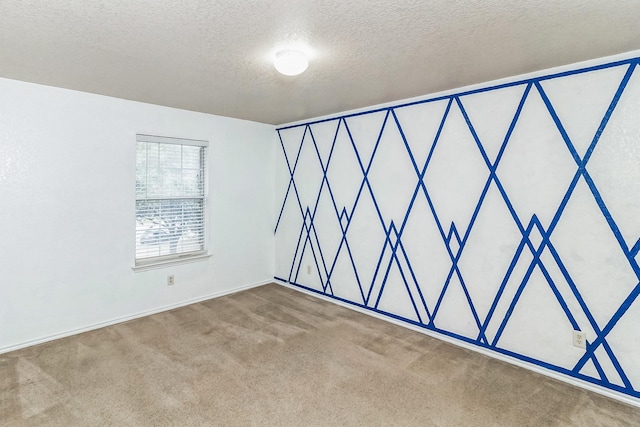 empty room featuring carpet floors and a textured ceiling