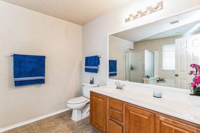 bathroom featuring an enclosed shower, vanity, and toilet