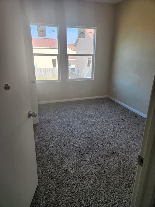 empty room with dark carpet