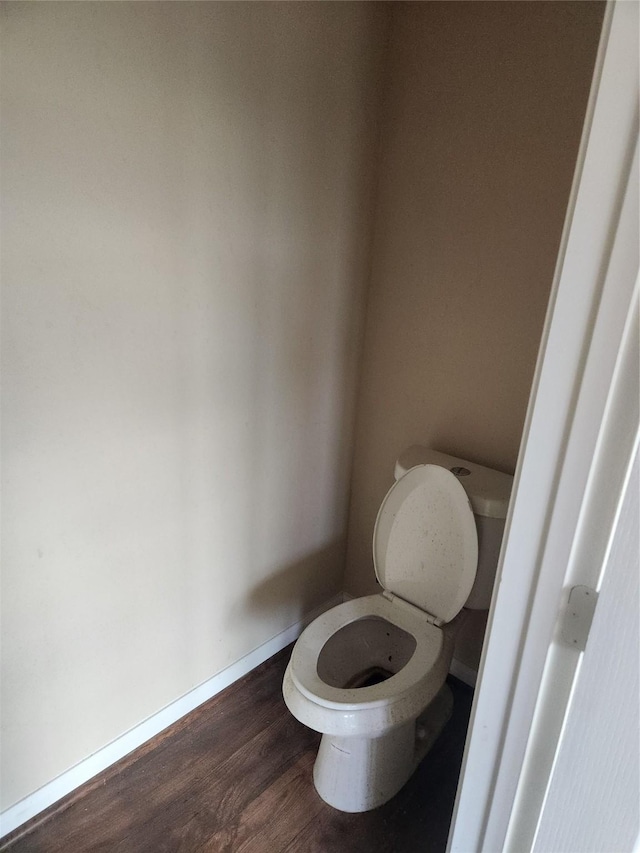 bathroom featuring wood-type flooring and toilet