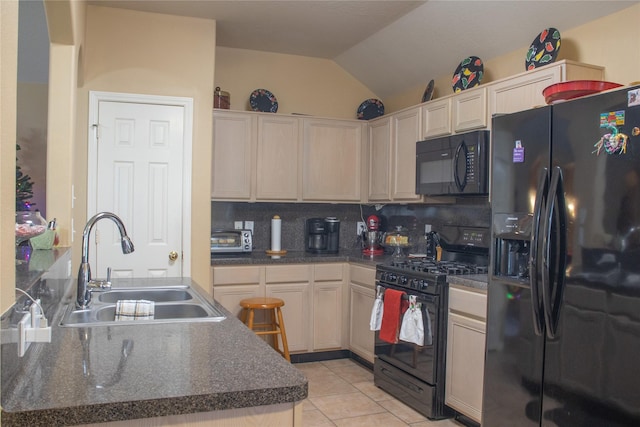 kitchen with backsplash, black appliances, sink, vaulted ceiling, and light tile patterned flooring