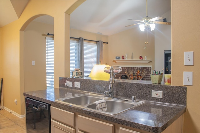 kitchen featuring dishwasher, sink, a brick fireplace, ceiling fan, and light tile patterned floors