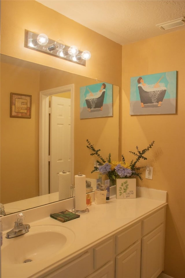 bathroom with vanity and a textured ceiling