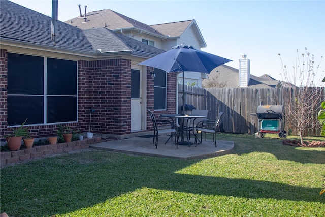 back of property featuring a patio area and a lawn