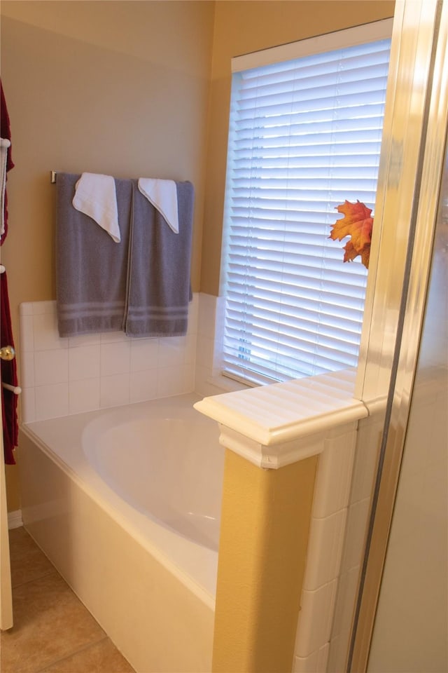 bathroom featuring a tub to relax in and tile patterned flooring