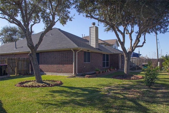 rear view of house featuring a yard