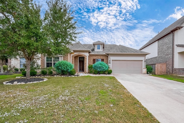 view of front facade with a front lawn and a garage