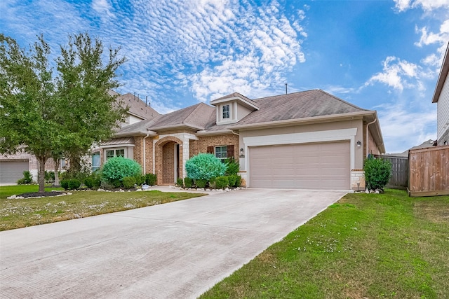 view of front of house featuring a garage and a front lawn