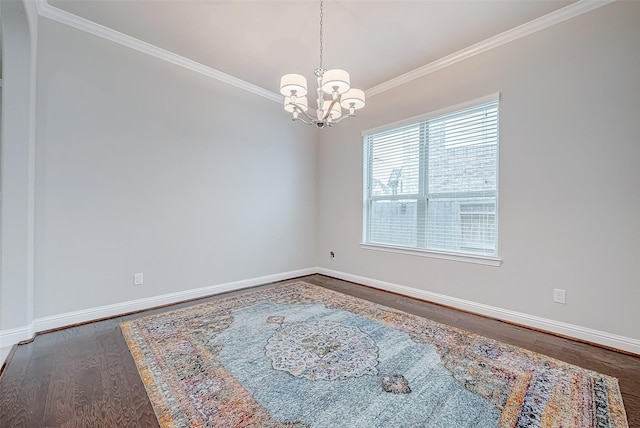 unfurnished room featuring wood-type flooring, ornamental molding, and an inviting chandelier