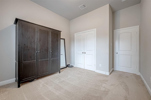 unfurnished bedroom with light colored carpet