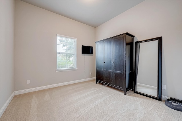 unfurnished bedroom with light colored carpet