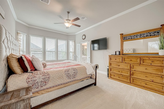 bedroom featuring carpet floors, ensuite bathroom, ceiling fan, and crown molding