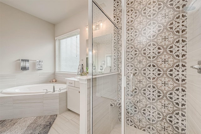 bathroom with tile patterned flooring, vanity, and shower with separate bathtub