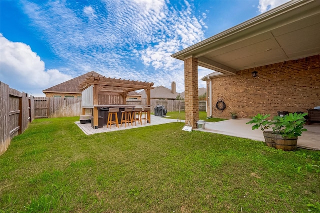 view of yard with a pergola, exterior bar, and a patio