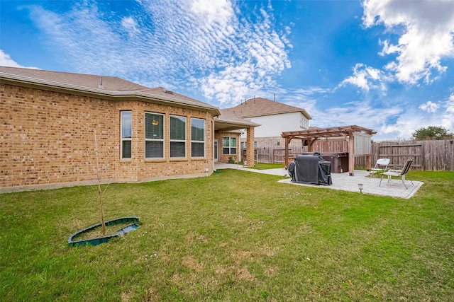 rear view of property featuring a pergola, a patio, and a lawn