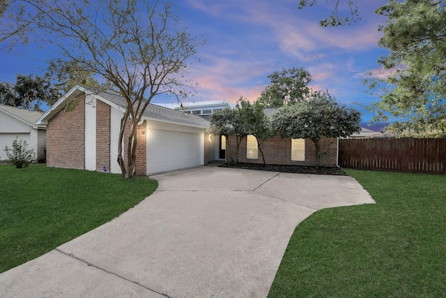 view of front facade with a garage and a lawn