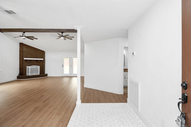 unfurnished living room featuring a fireplace, wood-type flooring, ceiling fan, and lofted ceiling