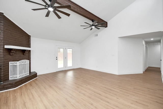 unfurnished living room featuring beam ceiling, light wood-type flooring, high vaulted ceiling, and a brick fireplace