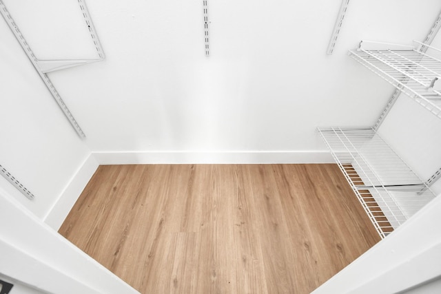 spacious closet featuring hardwood / wood-style flooring