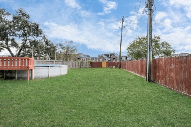 view of yard with a pool side deck