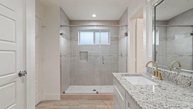 bathroom featuring vanity, wood-type flooring, and an enclosed shower