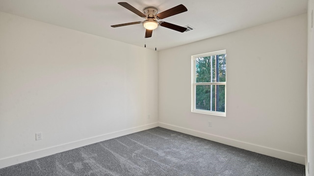 spare room with ceiling fan and carpet