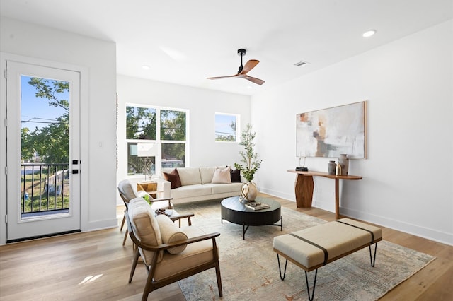 living room featuring ceiling fan and light wood-type flooring