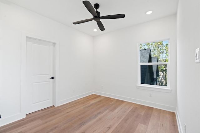 spare room with light wood-type flooring and ceiling fan