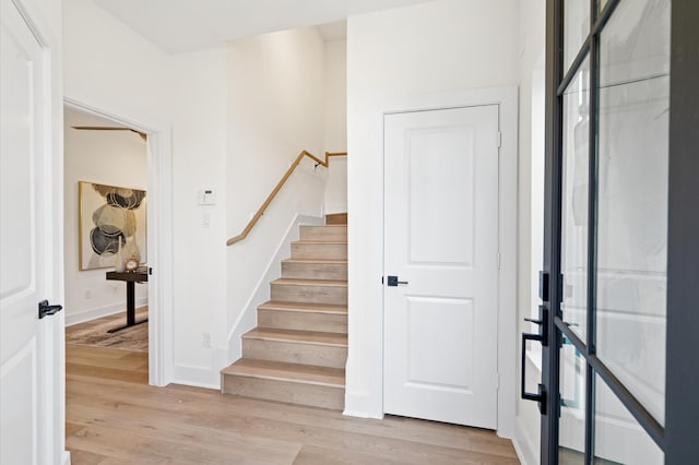 staircase with hardwood / wood-style floors