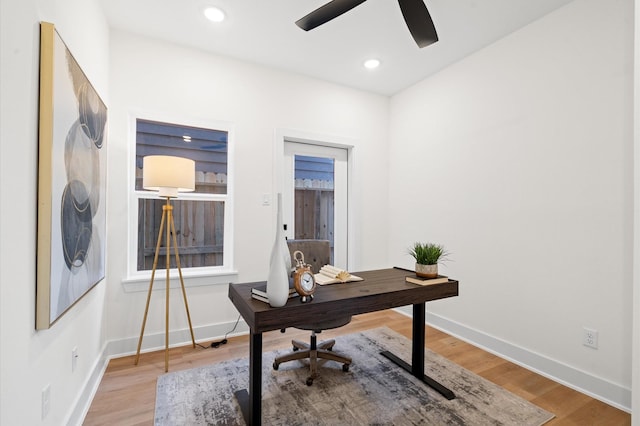 office with light hardwood / wood-style floors and ceiling fan