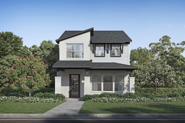 contemporary home featuring brick siding, a front yard, and a shingled roof