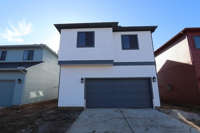 view of front of property featuring an attached garage and concrete driveway