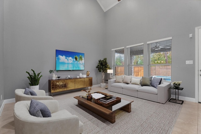 tiled living room featuring crown molding and a high ceiling