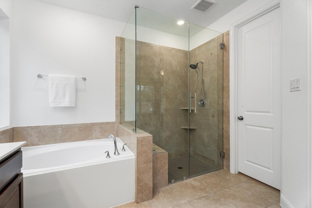 bathroom with tile patterned flooring, vanity, and separate shower and tub