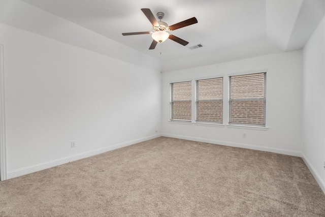 carpeted spare room featuring ceiling fan