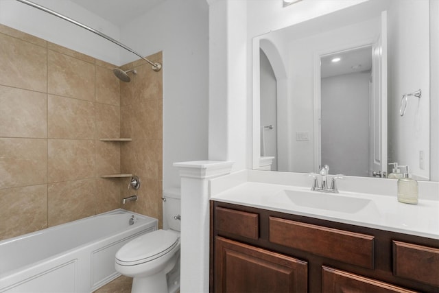 full bathroom featuring toilet, vanity, and tiled shower / bath