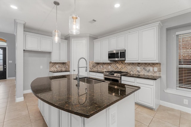 kitchen featuring a kitchen island with sink, sink, white cabinets, and stainless steel appliances