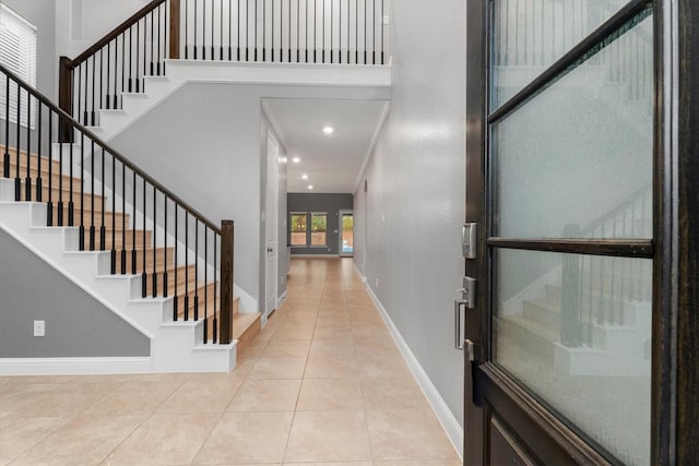 foyer entrance with light tile patterned floors