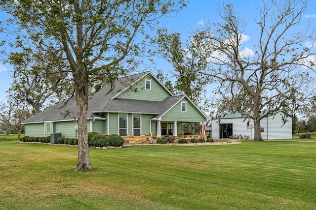 view of front facade with central air condition unit and a front yard