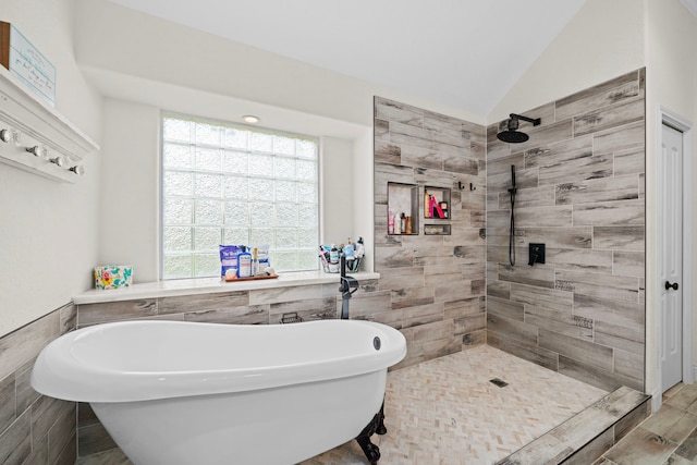 bathroom featuring separate shower and tub, lofted ceiling, and tile walls