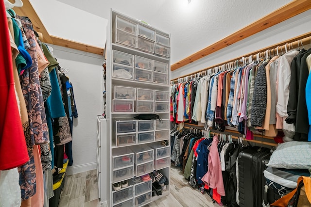 spacious closet with light hardwood / wood-style flooring