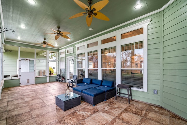 sunroom featuring ceiling fan