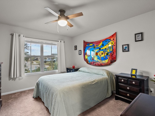 bedroom featuring light colored carpet and ceiling fan