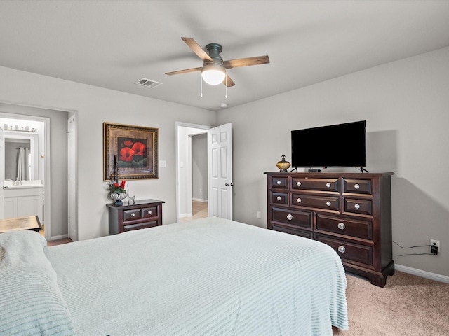 bedroom with connected bathroom, ceiling fan, and light colored carpet